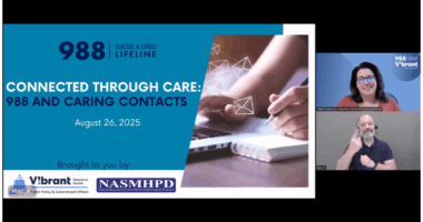 A webinar slide titled “Connected Through Care: 988 and Caring Contacts – August 26, 2025” appears on the left, featuring the 988 Suicide & Crisis Lifeline branding and logos for Vibrant Emotional Health and NASMHPD. The slide shows a person writing in a notebook with floating envelope icons. On the right side of the screen, two video panels show a Vibrant staff member speaking and an ASL interpreter signing.